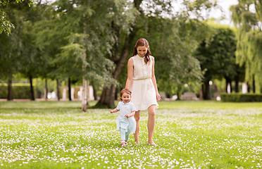 Image showing mother with baby girl walking at summer park