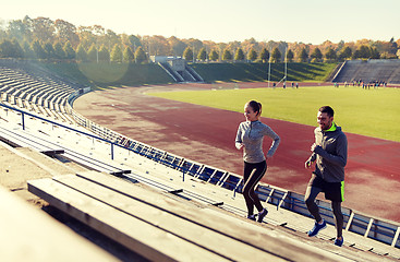 Image showing happy couple running upstairs on stadium