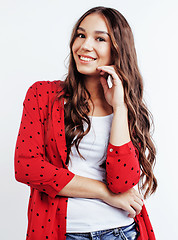 Image showing young pretty teenage hipster girl posing emotional happy smiling on white background, lifestyle people concept 