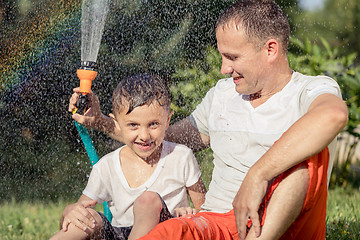 Image showing Happy father and son playing in the garden at the day time.