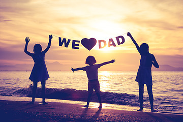 Image showing Happy children playing on the beach at the sunset time.