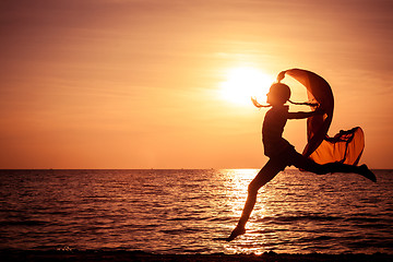 Image showing Happy girl jumping on the beach