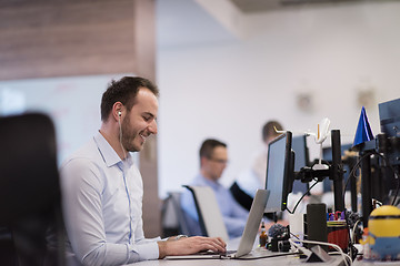 Image showing businessman working using a laptop in startup office