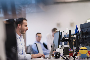 Image showing businessman working using a laptop in startup office