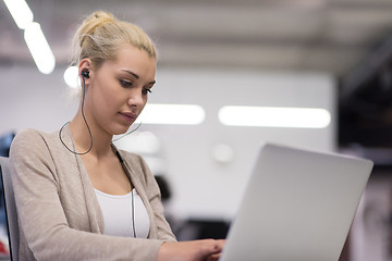 Image showing businesswoman using a laptop in startup office