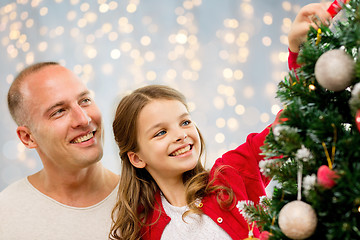 Image showing father and daughter decorating christmas tree