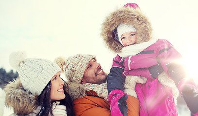 Image showing happy family with child in winter clothes outdoors