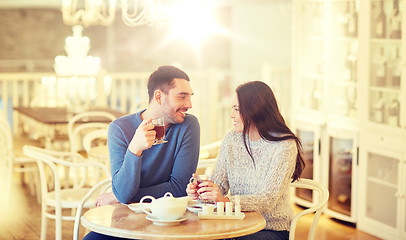 Image showing happy couple drinking tea at cafe