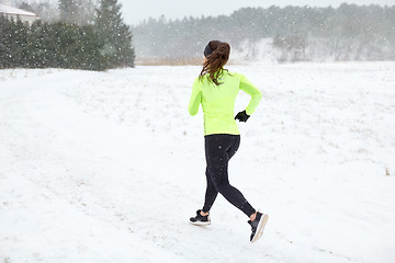 Image showing woman running outdoors in winter