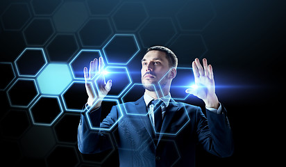 Image showing businessman working with virtual network hologram