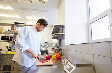 Image showing happy male chef cooking food at restaurant kitchen