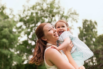 Image showing happy mother holding baby girl at summer park