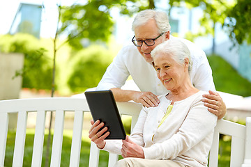 Image showing happy senior couple with tablet pc at summer park