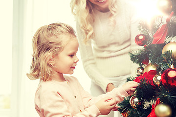 Image showing happy family decorating christmas tree at home