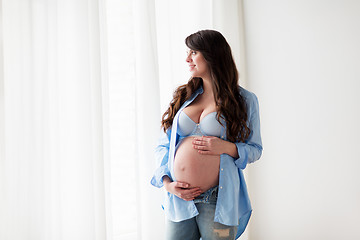 Image showing happy pregnant woman with big tummy at home