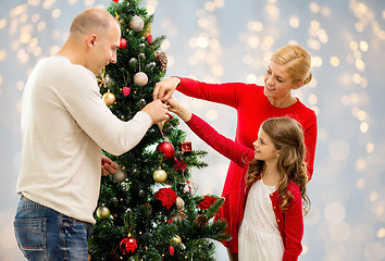 Image showing mother, father and daughter at christmas tree