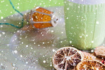 Image showing Cup, christmas light bulb and cuted fruits