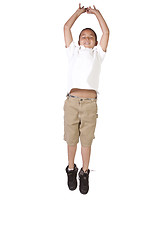 Image showing Young boy jumping over white background