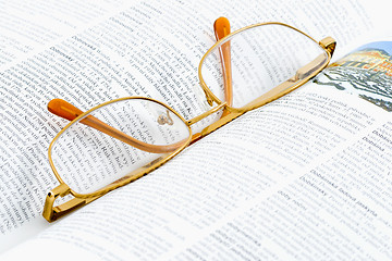 Image showing Glasses on a Book