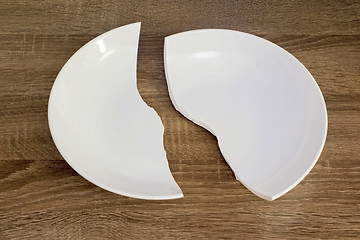 Image showing White broken plate on the table