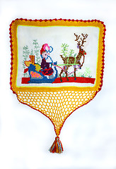Image showing embroidered figure of a deer and a man in a sleigh