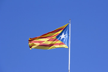 Image showing Catalan flag on the wind in blue sky