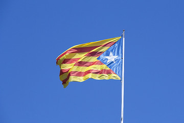 Image showing Catalan flag on the wind in blue sky