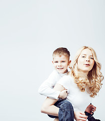 Image showing young modern blond curly mother with cute son together happy smiling family posing cheerful on white background, lifestyle people concept, sister and brother friends 