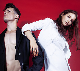 Image showing young fashion style couple man and woman on red sexy background, luxury stuff, lifestyle modern people sale concept 
