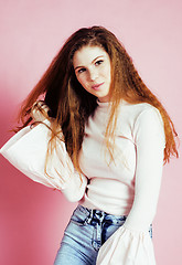 Image showing cute pretty redhair teenage girl smiling cheerful on pink background, lifestyle modern people concept 