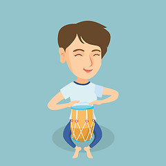 Image showing Young caucasian woman playing the ethnic drum.