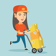 Image showing Woman-postman pushing the trolley with parcels.