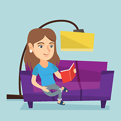 Image showing Young caucasian woman reading a book on sofa.