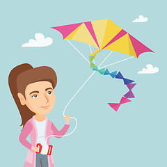 Image showing Young caucasian woman flying kite.