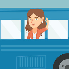 Image showing Young caucasian woman waving hand from bus window.