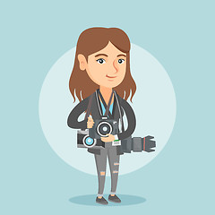 Image showing Young caucasian photographer with photo cameras.