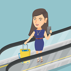 Image showing Woman using smartphone on escalator at the airport