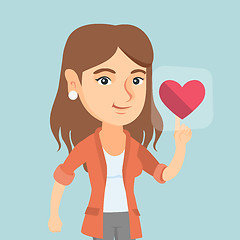 Image showing Young caucasian woman pressing heart shaped button