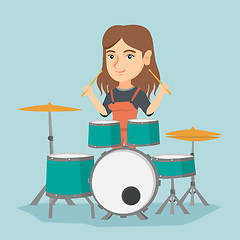 Image showing Young caucasian woman playing the drum.