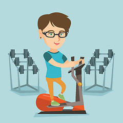 Image showing Caucasian woman exercising on elliptical trainer.