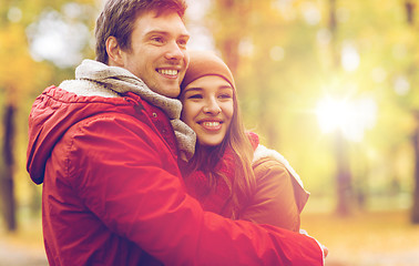 Image showing happy young couple hugging in autumn park