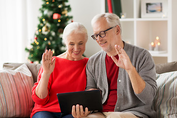 Image showing happy senior couple with tablet pc at christmas