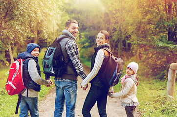 Image showing happy family with backpacks hiking