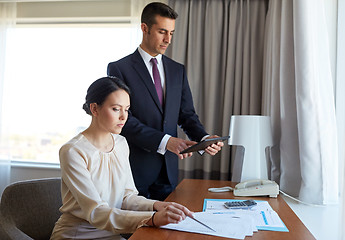 Image showing business team with papers working at hotel room