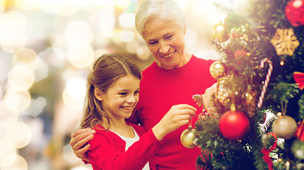 Image showing grandmother and granddaughter at christmas tree