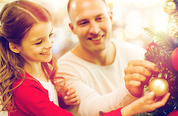 Image showing father and daughter decorating christmas tree