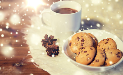 Image showing cups of hot chocolate with cookies on fur rug