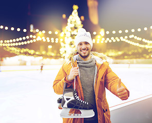 Image showing man showing thumbs up on christmas skating rink