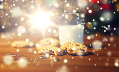 Image showing close up of cookies and milk over christmas lights