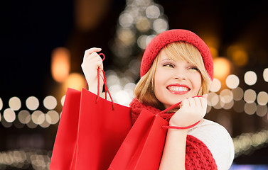 Image showing happy woman with shopping bags over christmas tree